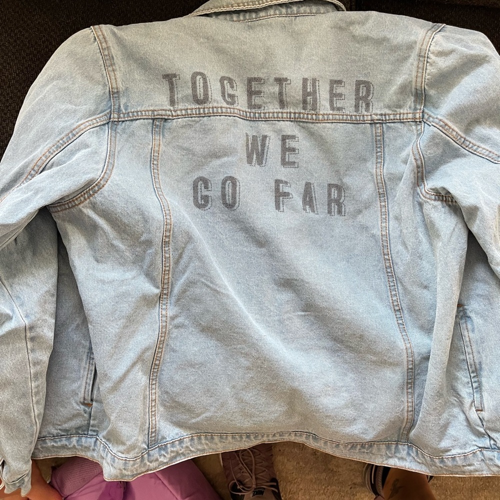 Denim jacket with slogan on back
